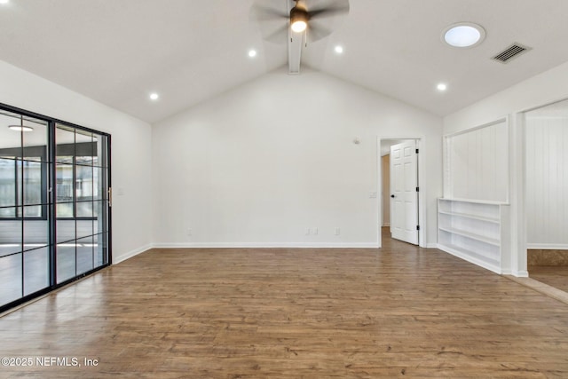 spare room featuring baseboards, ceiling fan, visible vents, and wood finished floors