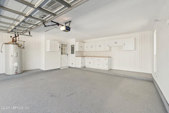 garage with water heater, electric panel, and a garage door opener