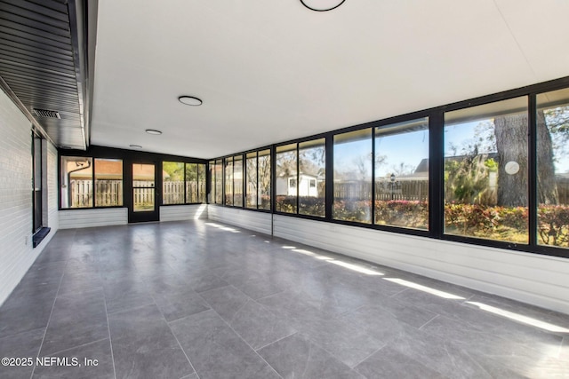 unfurnished sunroom with plenty of natural light