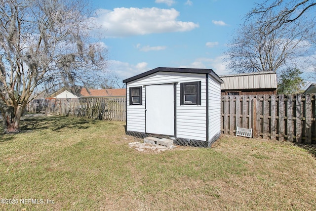 view of shed with a fenced backyard