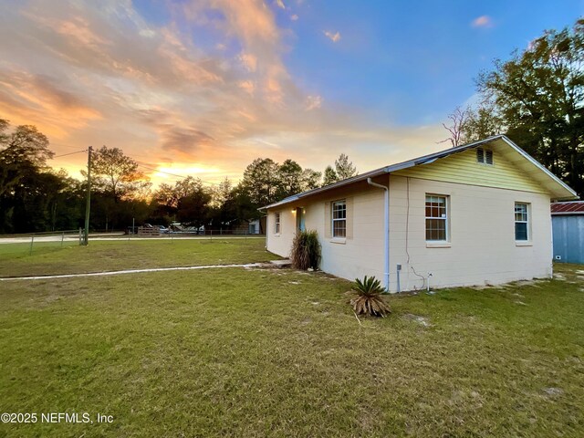 view of property exterior featuring a lawn