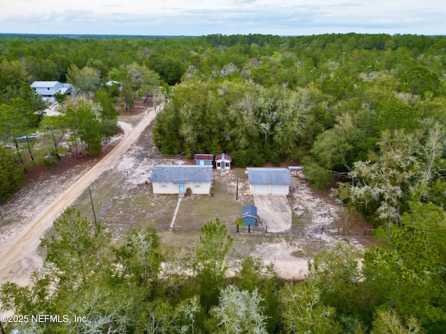 drone / aerial view featuring a forest view