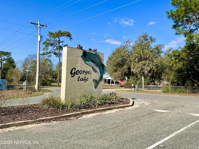 community sign featuring fence