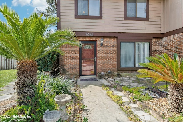 property entrance featuring brick siding