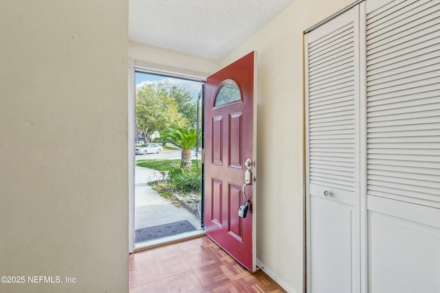 entryway featuring a textured ceiling