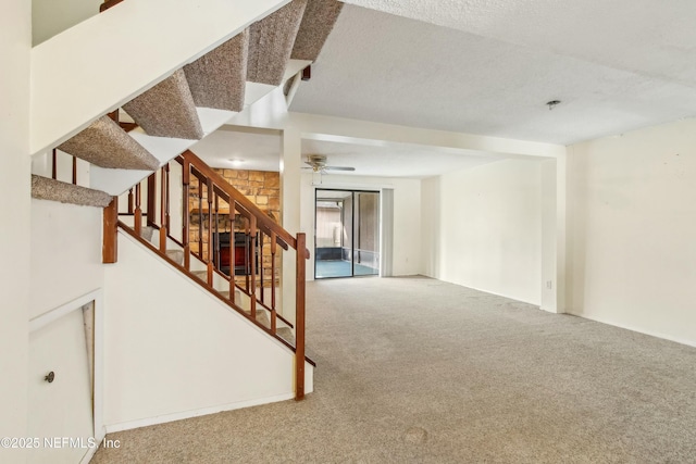 carpeted spare room with a textured ceiling and stairway