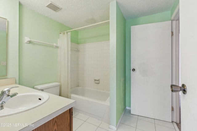 bathroom with tile patterned flooring, visible vents, a textured ceiling, and vanity