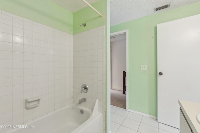 full bathroom featuring visible vents, bathing tub / shower combination, tile patterned flooring, a textured ceiling, and vanity