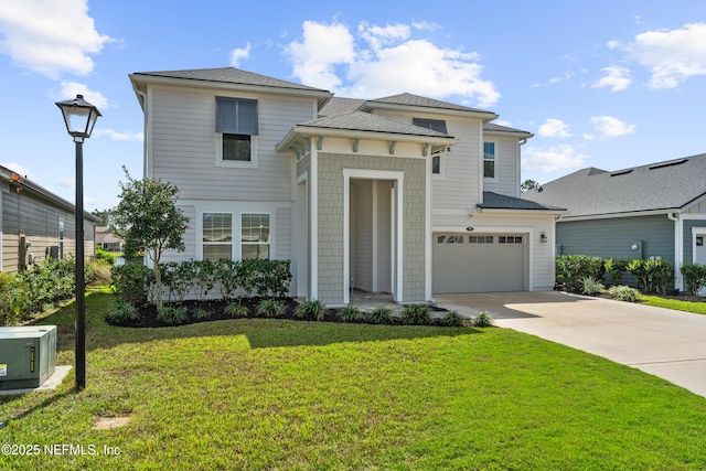 view of front of home featuring a front yard, an attached garage, and driveway