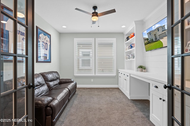 office with plenty of natural light, dark carpet, built in study area, and baseboards