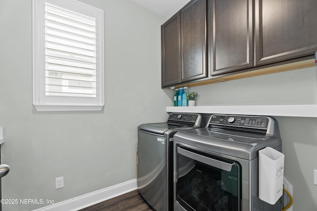 washroom with dark wood finished floors, separate washer and dryer, cabinet space, and baseboards