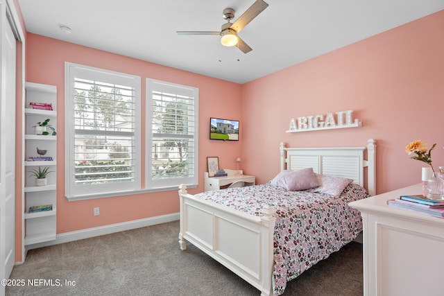 carpeted bedroom featuring baseboards and ceiling fan