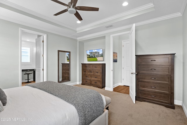 bedroom featuring baseboards, a raised ceiling, light colored carpet, and crown molding