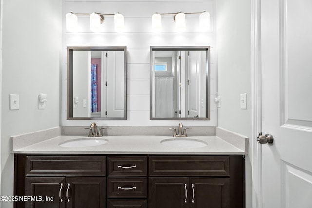 full bath with double vanity and a sink