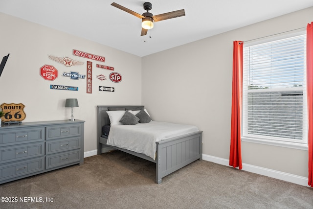 carpeted bedroom featuring baseboards and ceiling fan