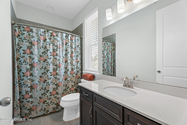 full bathroom with tile patterned floors, a shower with shower curtain, toilet, and vanity