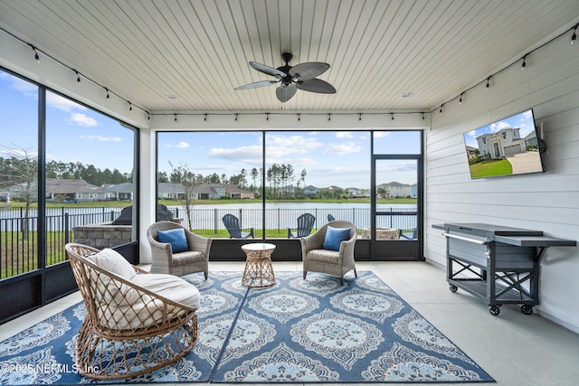 sunroom with track lighting and a ceiling fan