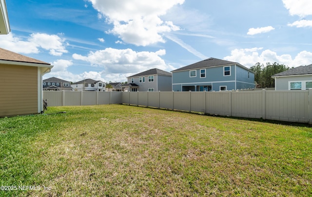 view of yard featuring fence and a residential view