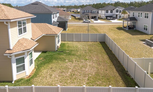 view of yard featuring a residential view and a fenced backyard