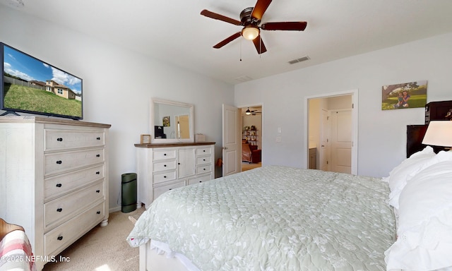 bedroom featuring visible vents, a ceiling fan, and light colored carpet