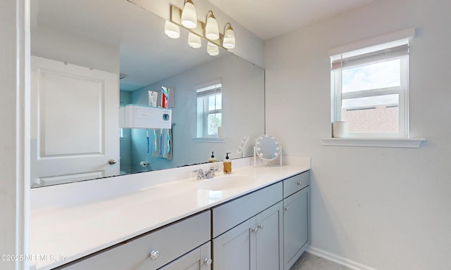 bathroom with vanity and baseboards