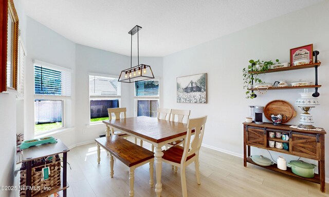 dining room with light wood-style flooring and baseboards