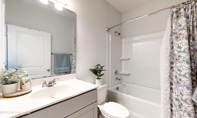 full bathroom featuring a textured wall, vanity, toilet, and shower / bath combo with shower curtain