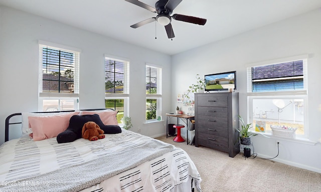 bedroom featuring baseboards, a ceiling fan, and light colored carpet