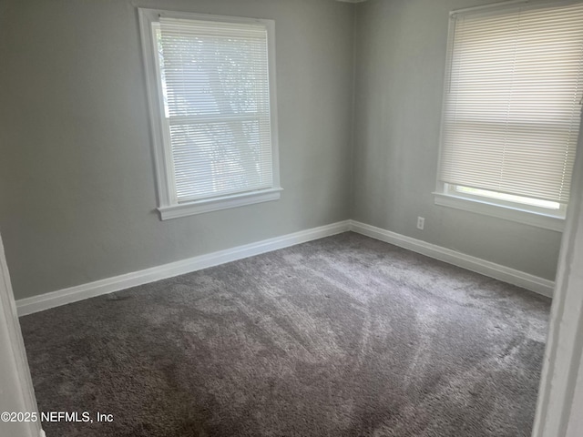 carpeted empty room with baseboards