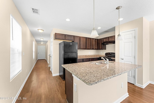 8120 Dandy Ave, Jacksonville, FL 32211 - kitchen featuring dark brown cabinetry, visible vents, under cabinet range hood, black appliances, and a sink