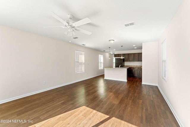 8120 Dandy Ave, Jacksonville, FL 32211 - unfurnished living room with dark wood-style flooring, visible vents, and baseboards