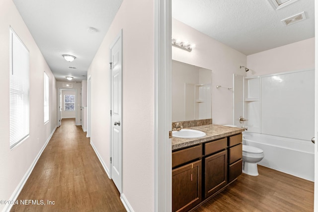 8120 Dandy Ave, Jacksonville, FL 32211 - full bath with washtub / shower combination, visible vents, wood finished floors, and vanity