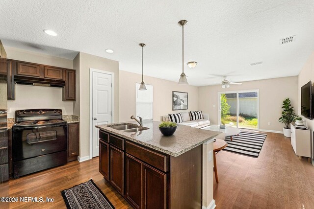 8120 Dandy Ave, Jacksonville, FL 32211 - kitchen with visible vents, open floor plan, a sink, under cabinet range hood, and black / electric stove