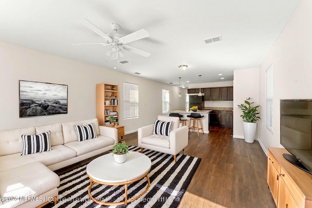 8120 Dandy Ave, Jacksonville, FL 32211 - living area featuring a ceiling fan, dark wood finished floors, visible vents, and baseboards