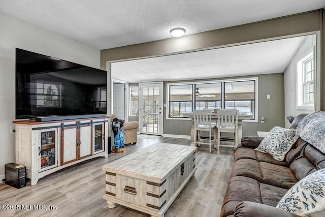 living area featuring a textured ceiling and wood finished floors