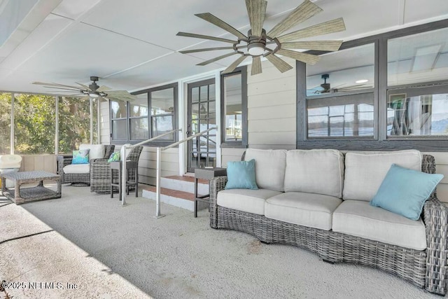 sunroom featuring plenty of natural light and a ceiling fan