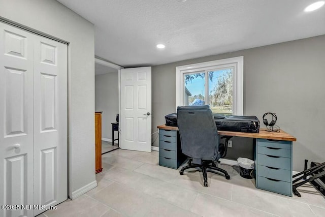 office space featuring recessed lighting, a textured ceiling, baseboards, and light tile patterned floors