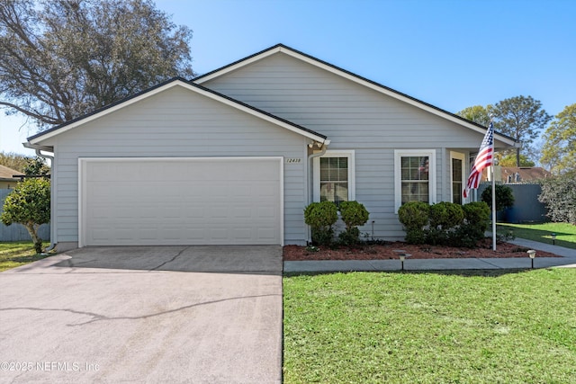 single story home featuring a front yard, concrete driveway, fence, and a garage