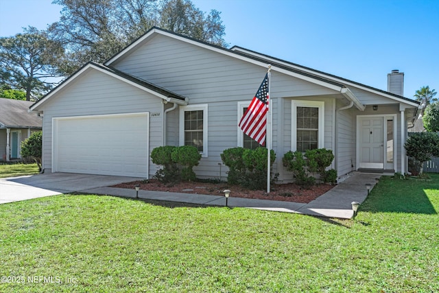 ranch-style house featuring a chimney, an attached garage, concrete driveway, and a front yard