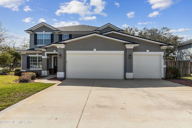 view of front of home with a garage, fence, concrete driveway, and stucco siding