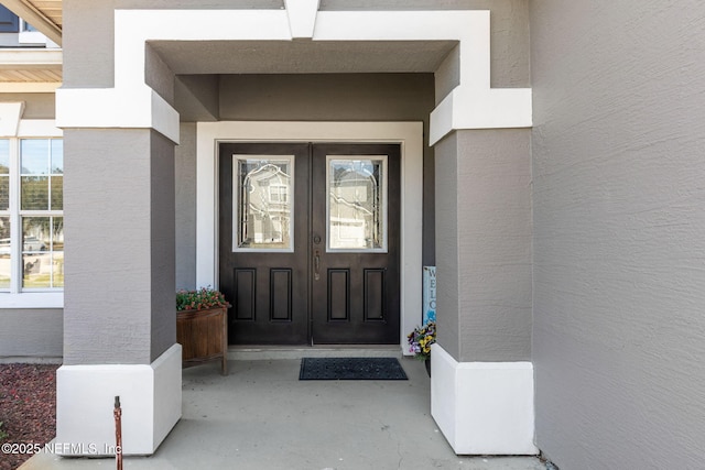 doorway to property with french doors and stucco siding