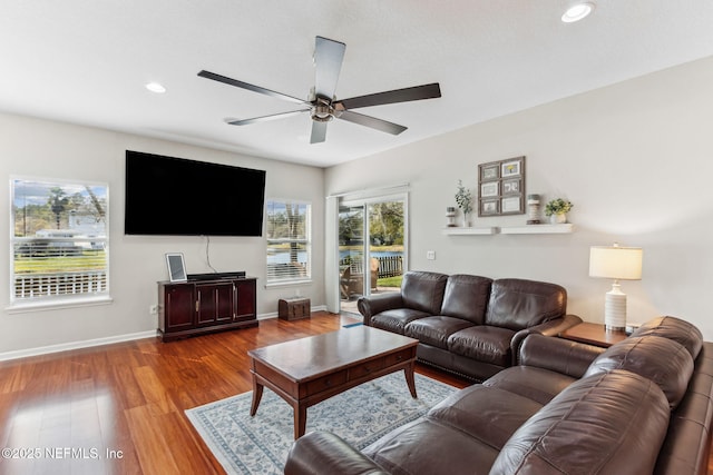 living area featuring ceiling fan, baseboards, wood finished floors, and recessed lighting