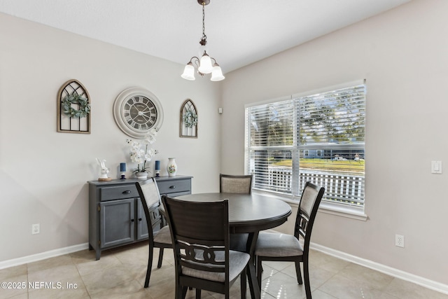 dining room with an inviting chandelier, baseboards, and light tile patterned flooring