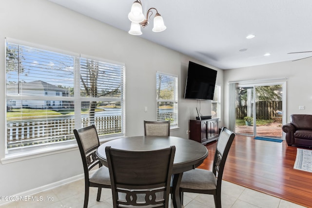 dining room featuring light tile patterned floors, recessed lighting, baseboards, and an inviting chandelier