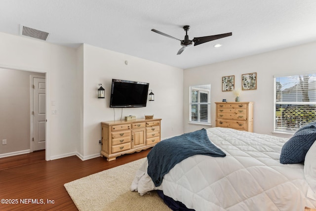 bedroom featuring recessed lighting, visible vents, dark wood-type flooring, a ceiling fan, and baseboards