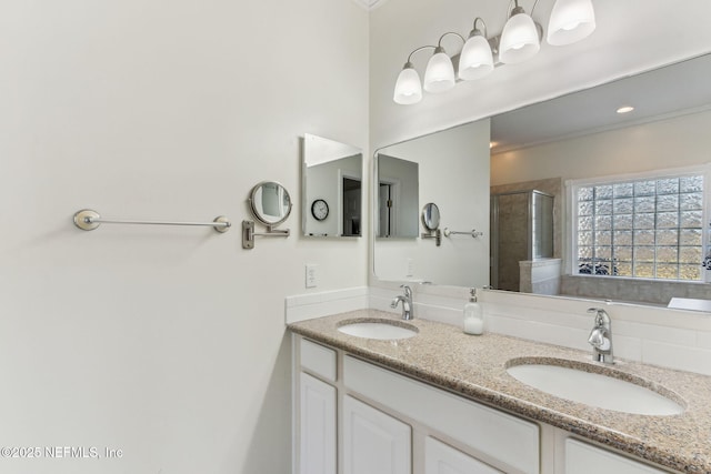 bathroom with double vanity, a sink, and a shower stall