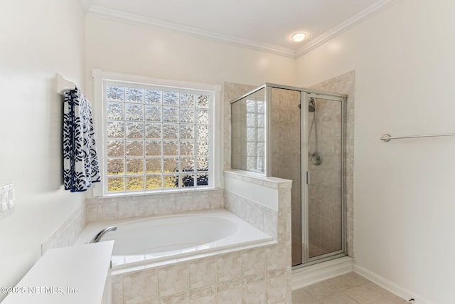 bathroom with a stall shower, tile patterned flooring, a garden tub, and crown molding