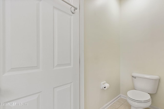 bathroom featuring baseboards, toilet, and tile patterned floors