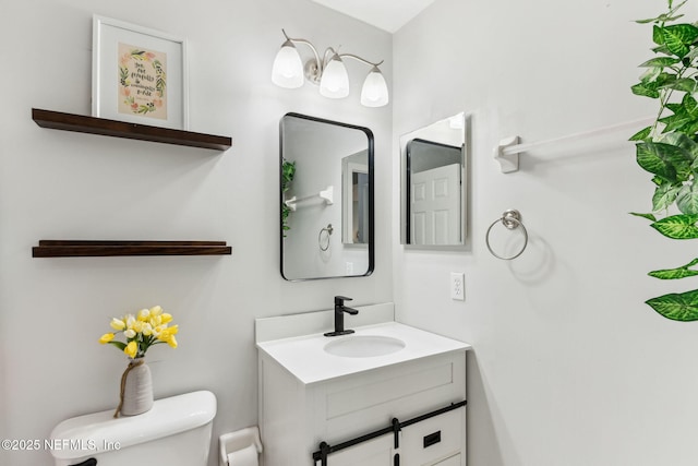 bathroom with toilet and vanity