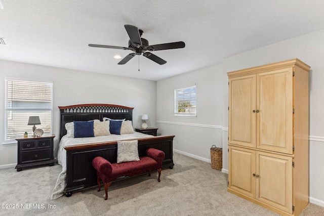 bedroom with baseboards, a ceiling fan, and light colored carpet